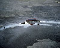 Topless bar reflected in puddle, Doylestown, Penna. 2010